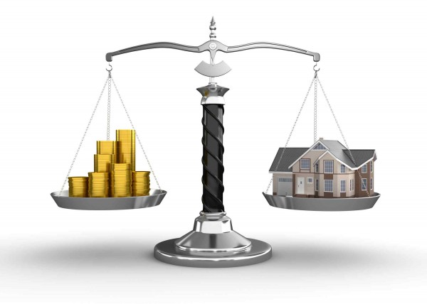 House and money on scale